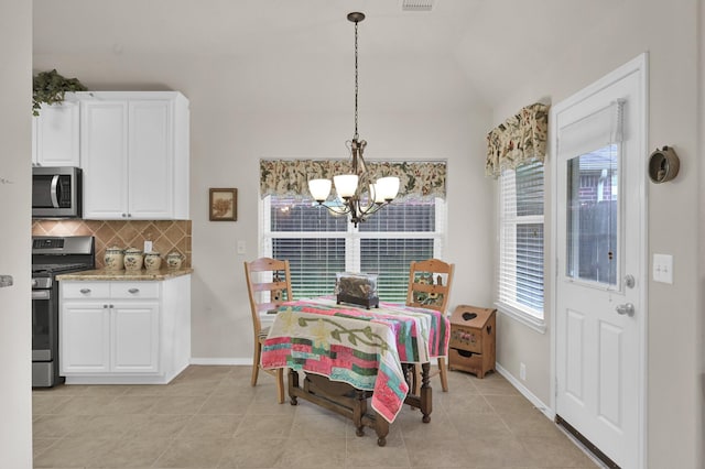 30302 Castle Forest Dr, Spring, TX 77386 - dining area with a chandelier, light tile patterned floors, and lofted ceiling