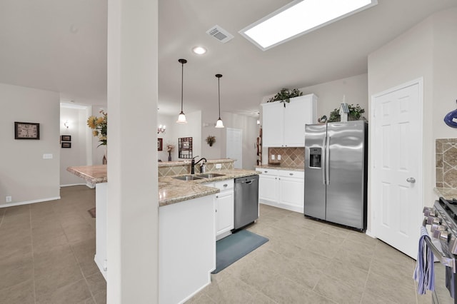 30302 Castle Forest Dr, Spring, TX 77386 - kitchen featuring appliances with stainless steel finishes, decorative backsplash, light tile patterned floors, white cabinetry, and recessed lighting