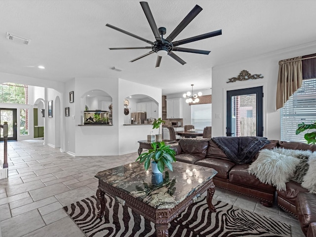 11938 Galentine Pt, Cypress, TX 77429 - living area featuring a chandelier, ceiling fan, arched walkways, a textured ceiling, and recessed lighting