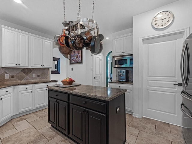 11938 Galentine Pt, Cypress, TX 77429 - kitchen with stainless steel appliances, dark cabinets, decorative backsplash, and white cabinetry