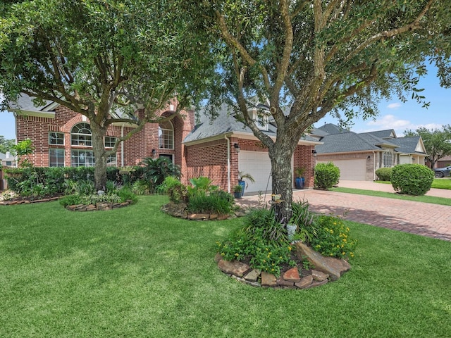 11938 Galentine Pt, Cypress, TX 77429 - view of front facade featuring brick siding, a garage, decorative driveway, a front yard, and roof with shingles