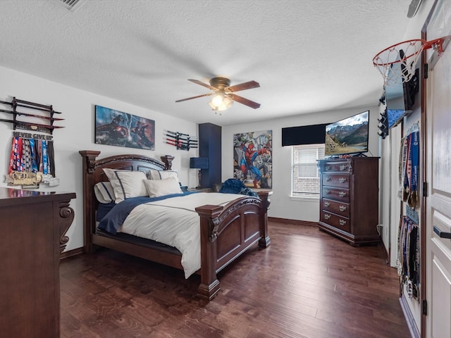 11938 Galentine Pt, Cypress, TX 77429 - bedroom featuring dark wood-type flooring, a textured ceiling, and ceiling fan