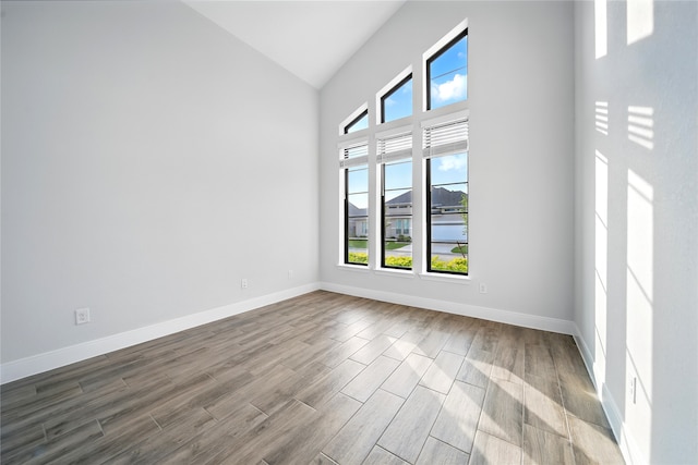 18011 Brazos River Cir, Cypress, TX 77433 - spare room featuring dark wood-style flooring and high vaulted ceiling
