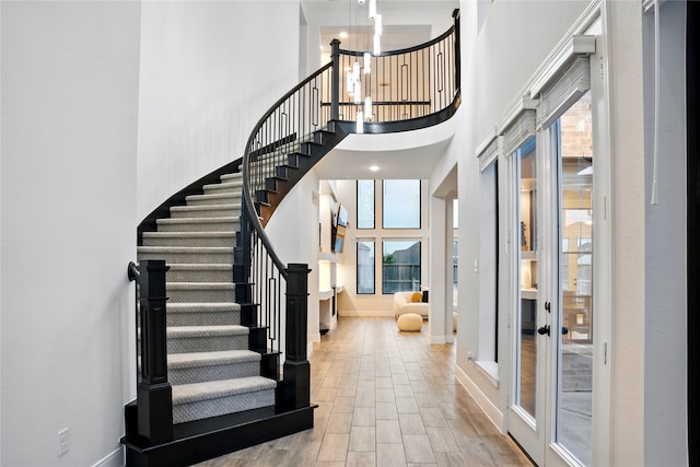 18011 Brazos River Cir, Cypress, TX 77433 - foyer with a high ceiling, stairs, wood finished floors, french doors, and a chandelier
