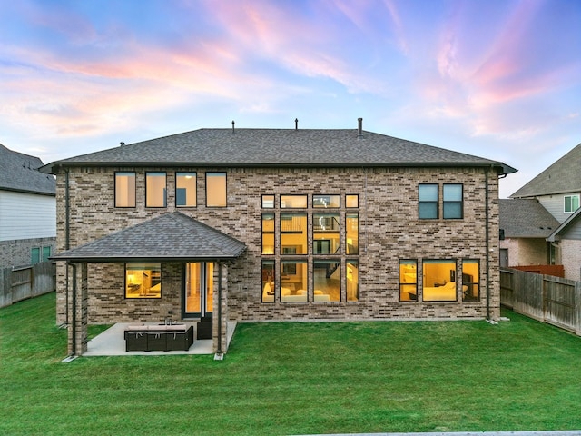 18011 Brazos River Cir, Cypress, TX 77433 - rear view of property featuring a patio area, roof with shingles, and brick siding