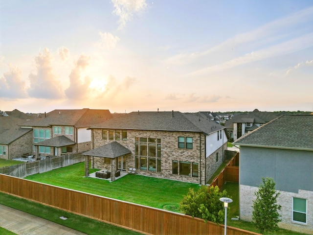 18011 Brazos River Cir, Cypress, TX 77433 - back of house featuring a gazebo, stone siding, a fenced backyard, a residential view, and a patio area