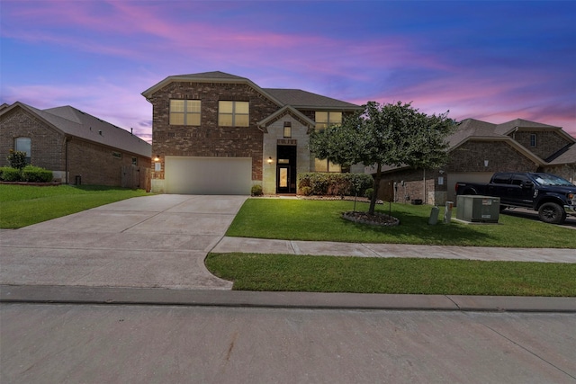 12137 Pearl Bay Ln, Conroe, TX 77304 - view of front of house featuring a front yard, concrete driveway, a garage, brick siding, and stone siding