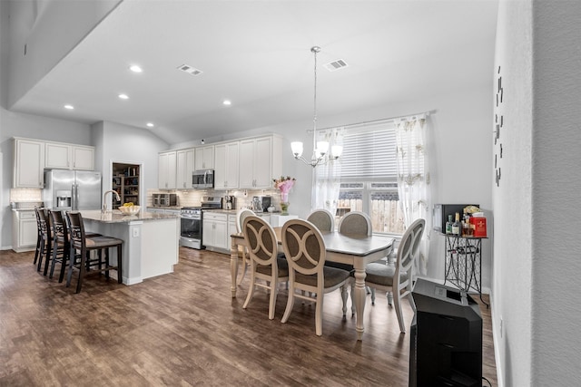 12137 Pearl Bay Ln, Conroe, TX 77304 - dining room with a chandelier, recessed lighting, dark wood-style flooring, and lofted ceiling