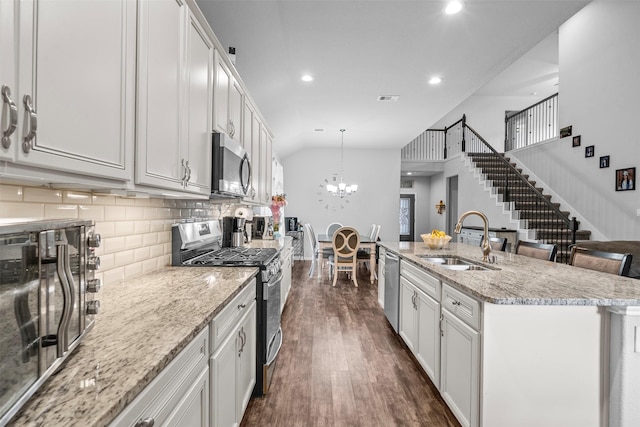 12137 Pearl Bay Ln, Conroe, TX 77304 - kitchen featuring stainless steel appliances, dark wood-type flooring, recessed lighting, tasteful backsplash, and white cabinets