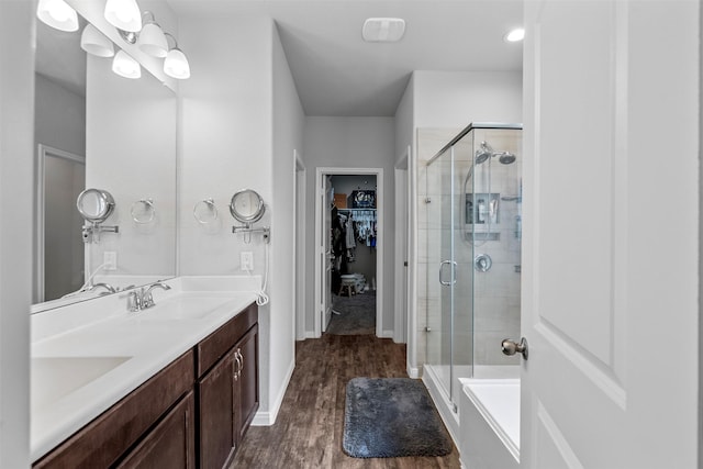 12137 Pearl Bay Ln, Conroe, TX 77304 - bathroom with a shower stall, double vanity, wood finished floors, and a walk in closet