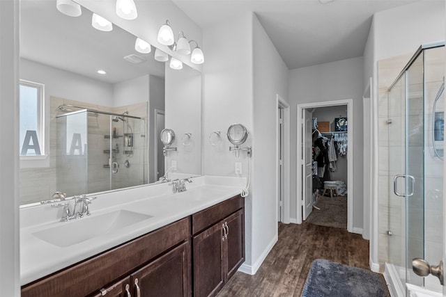 12137 Pearl Bay Ln, Conroe, TX 77304 - full bath with a walk in closet, a stall shower, double vanity, and wood finished floors