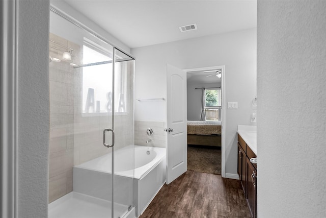 12137 Pearl Bay Ln, Conroe, TX 77304 - ensuite bathroom with wood finished floors, a shower stall, vanity, a garden tub, and a ceiling fan