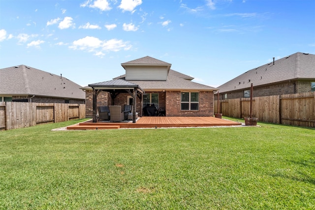 12137 Pearl Bay Ln, Conroe, TX 77304 - rear view of house featuring a gazebo, brick siding, a fenced backyard, a wooden deck, and roof with shingles