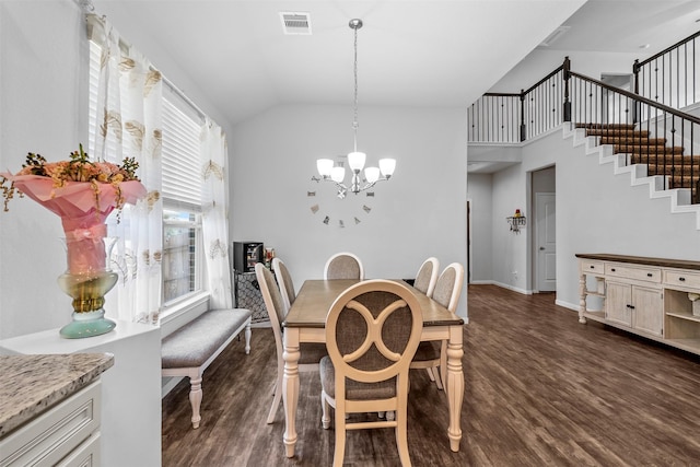 12137 Pearl Bay Ln, Conroe, TX 77304 - dining space featuring a chandelier, dark wood-type flooring, stairway, and high vaulted ceiling