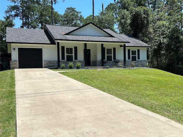 23918 Overcup Dr, Spring, TX 77389 - view of front of home featuring concrete driveway, roof with shingles, covered porch, a garage, and a front lawn