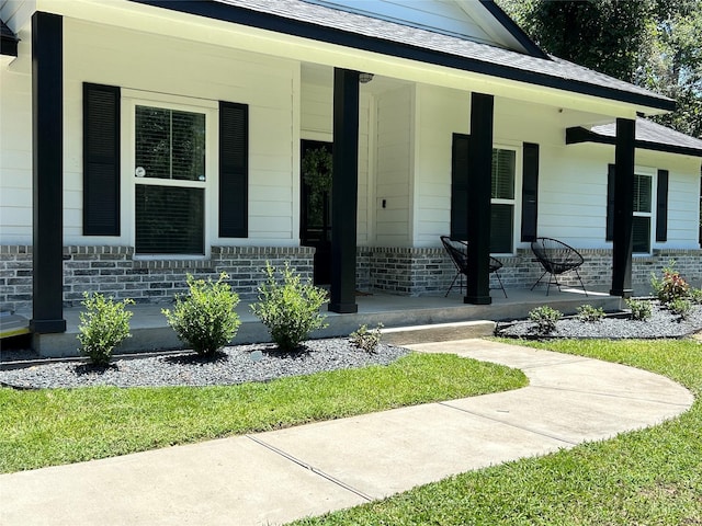 23918 Overcup Dr, Spring, TX 77389 - view of exterior entry with a porch and brick siding