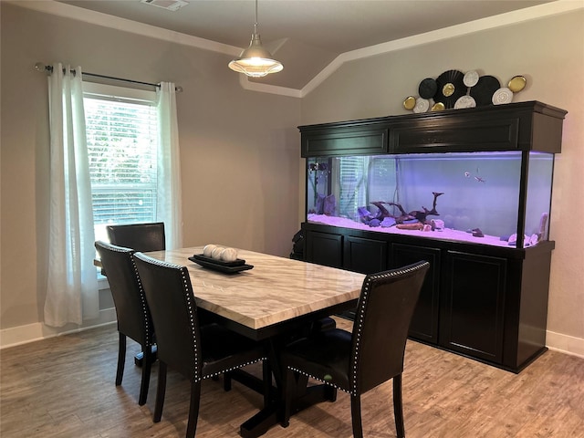 23918 Overcup Dr, Spring, TX 77389 - dining space with lofted ceiling, light wood finished floors, and crown molding