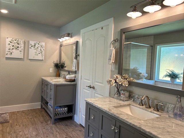23918 Overcup Dr, Spring, TX 77389 - full bath with two vanities, tiled shower, and wood finished floors