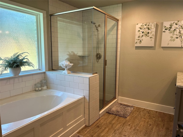 23918 Overcup Dr, Spring, TX 77389 - bathroom featuring a stall shower, a garden tub, wood finished floors, and vanity