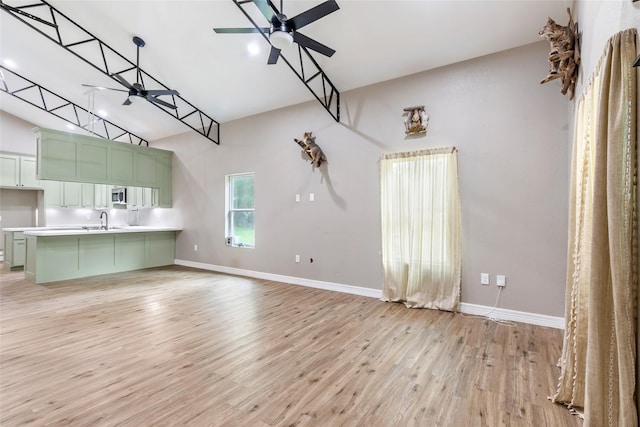 24824 W Christine Dr, Splendora, TX 77372 - unfurnished living room with a ceiling fan, light wood finished floors, and high vaulted ceiling