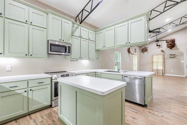 24824 W Christine Dr, Splendora, TX 77372 - kitchen with green cabinets, appliances with stainless steel finishes, a peninsula, light countertops, and light wood-type flooring