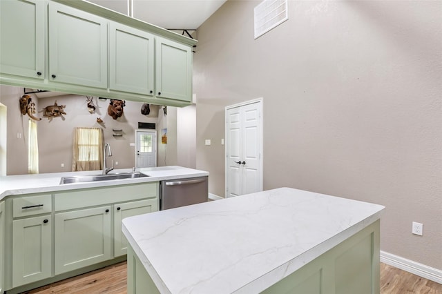 24824 W Christine Dr, Splendora, TX 77372 - kitchen with green cabinets, stainless steel dishwasher, light wood-type flooring, and a towering ceiling
