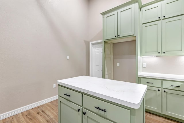 24824 W Christine Dr, Splendora, TX 77372 - kitchen with green cabinets, light wood-style floors, light countertops, and a kitchen island