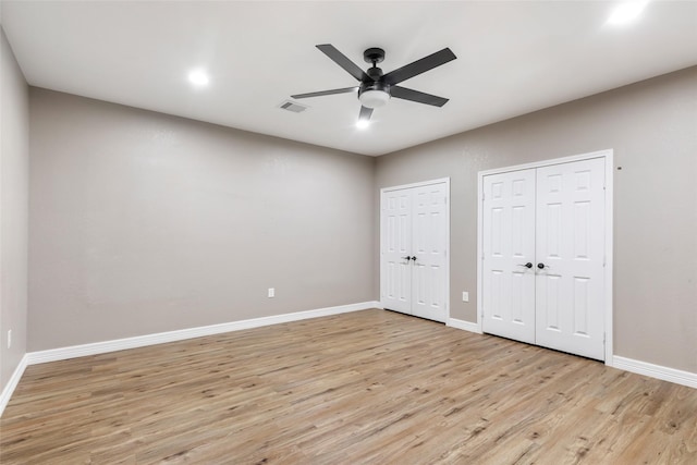 24824 W Christine Dr, Splendora, TX 77372 - unfurnished bedroom with two closets, light wood-style flooring, and ceiling fan