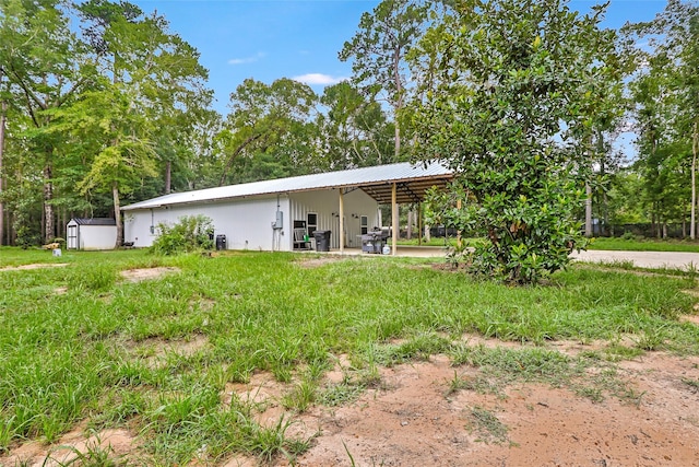 24824 W Christine Dr, Splendora, TX 77372 - rear view of house with an outdoor structure and a metal roof