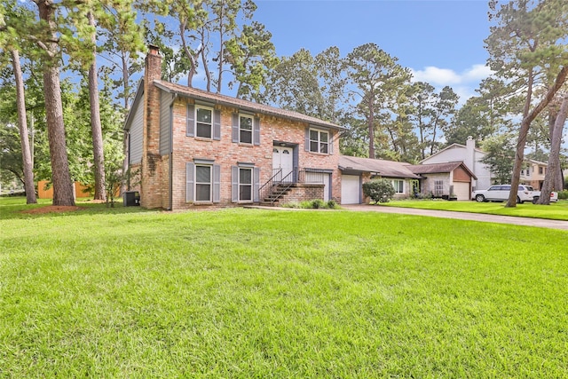 3203 Sycamore Springs Dr, Kingwood, TX 77339 - split foyer home with a chimney, driveway, brick siding, a front yard, and an attached garage