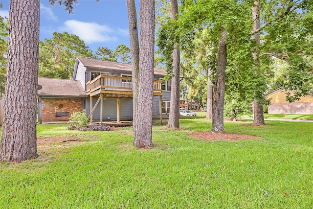 3203 Sycamore Springs Dr, Kingwood, TX 77339 - rear view of house featuring a lawn, a shingled roof, and brick siding