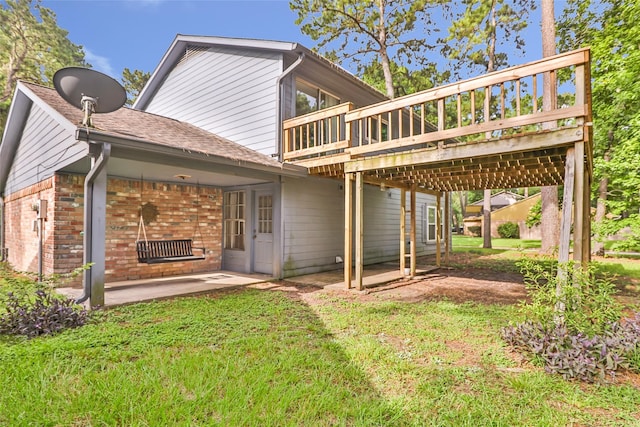 3203 Sycamore Springs Dr, Kingwood, TX 77339 - rear view of property with brick siding, a deck, a patio, a lawn, and roof with shingles