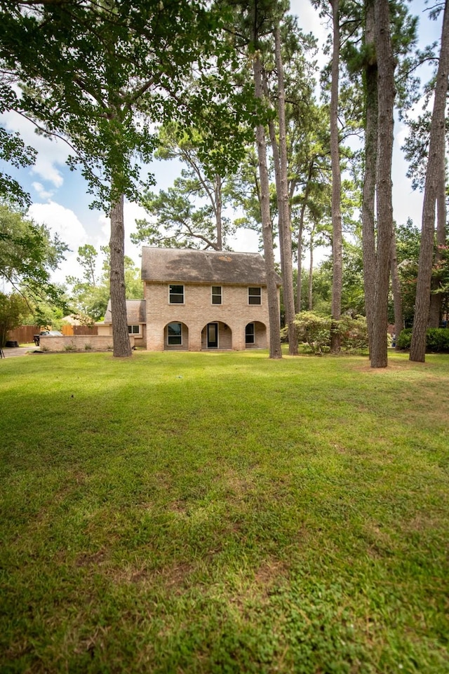17106 Spring Creek Forest Dr, Spring, TX 77379 - rear view of house with a yard