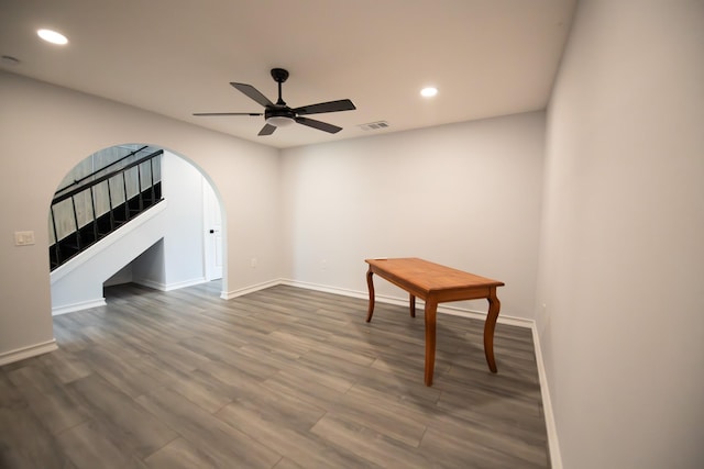 17106 Spring Creek Forest Dr, Spring, TX 77379 - empty room featuring a ceiling fan, recessed lighting, dark wood finished floors, and arched walkways