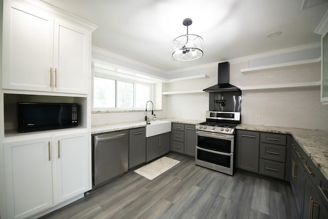 17106 Spring Creek Forest Dr, Spring, TX 77379 - kitchen with open shelves, stainless steel appliances, wall chimney range hood, gray cabinets, and a chandelier