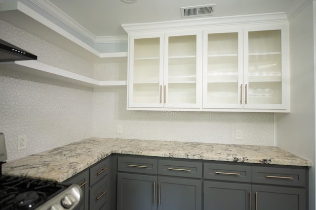 17106 Spring Creek Forest Dr, Spring, TX 77379 - kitchen featuring stove, backsplash, white cabinets, glass insert cabinets, and crown molding