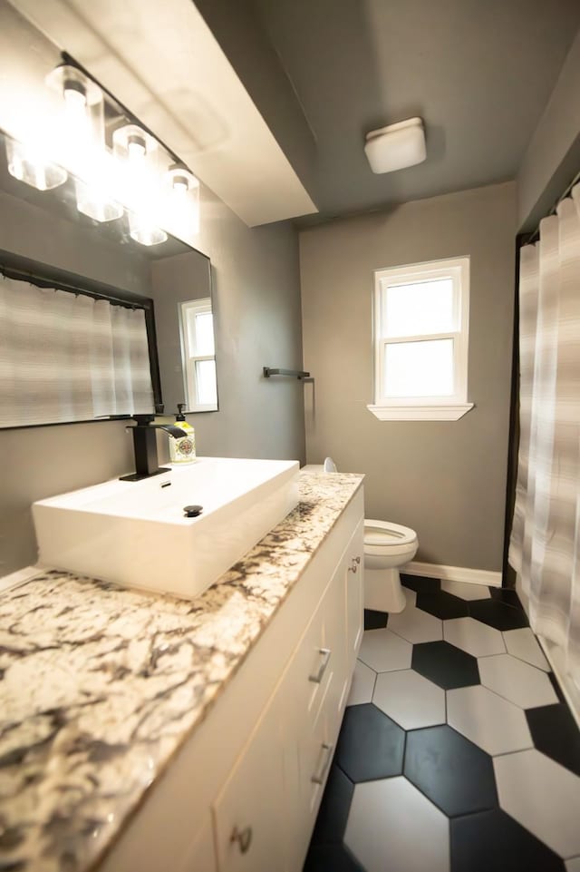 17106 Spring Creek Forest Dr, Spring, TX 77379 - bathroom featuring healthy amount of natural light, vanity, and tile patterned floors