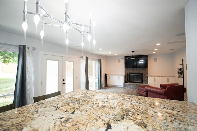 17106 Spring Creek Forest Dr, Spring, TX 77379 - living room featuring wood finished floors, a fireplace, french doors, and recessed lighting