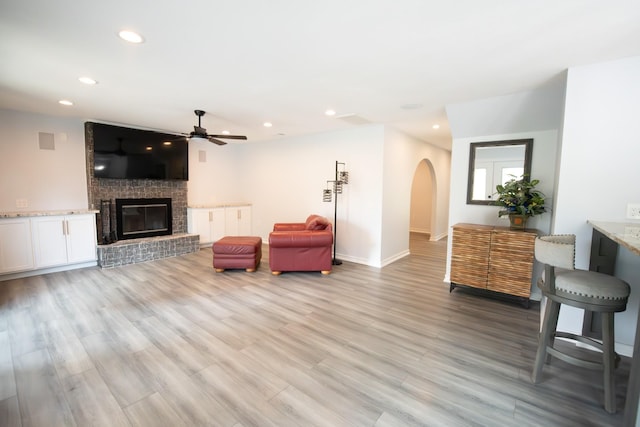 17106 Spring Creek Forest Dr, Spring, TX 77379 - living area featuring ceiling fan, recessed lighting, arched walkways, light wood-type flooring, and a brick fireplace