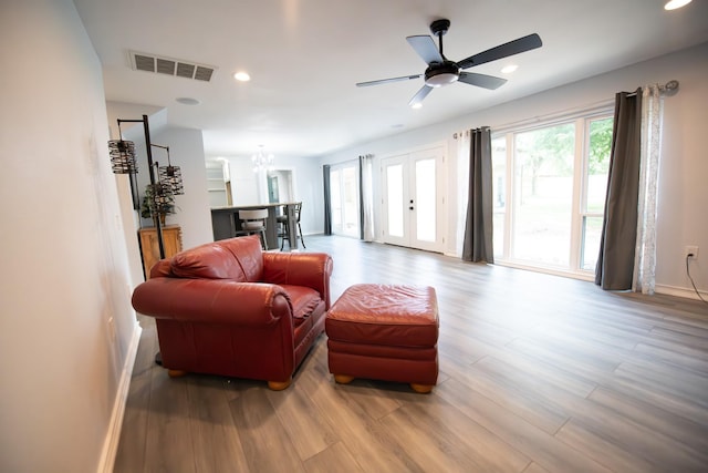 17106 Spring Creek Forest Dr, Spring, TX 77379 - living room with wood finished floors, ceiling fan, recessed lighting, a chandelier, and french doors