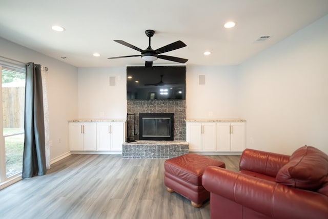 17106 Spring Creek Forest Dr, Spring, TX 77379 - living room with ceiling fan, light wood-style flooring, a brick fireplace, and recessed lighting