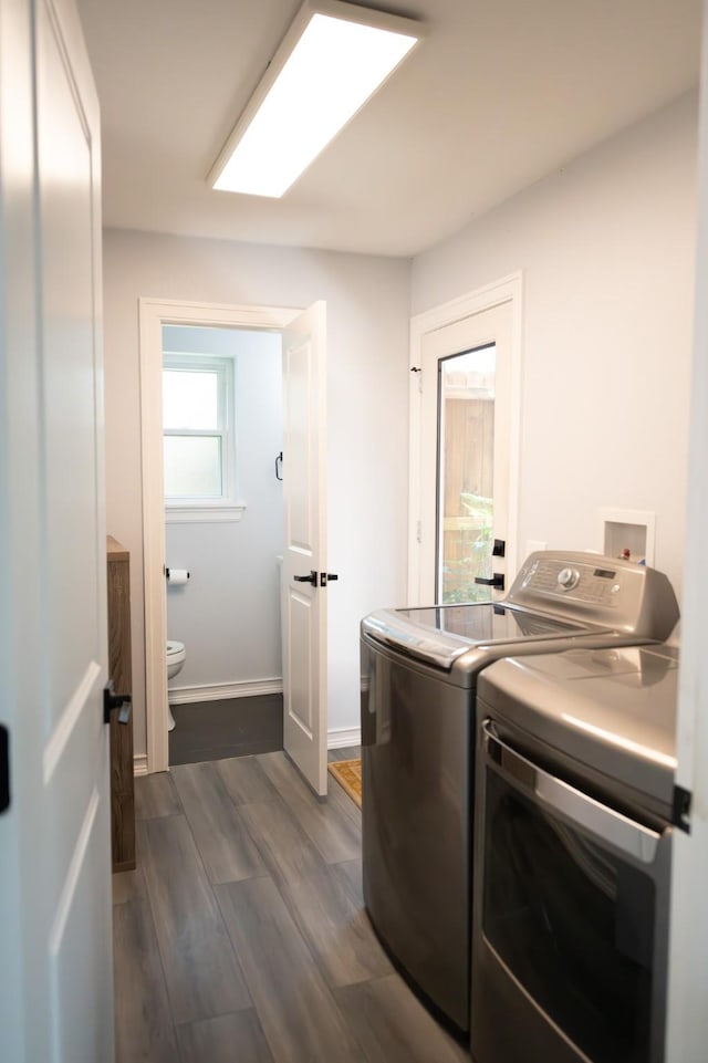 17106 Spring Creek Forest Dr, Spring, TX 77379 - laundry area featuring separate washer and dryer and dark wood-style flooring