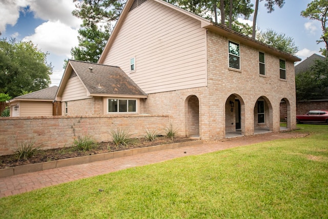 17106 Spring Creek Forest Dr, Spring, TX 77379 - rear view of house featuring brick siding and a yard
