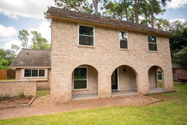 17106 Spring Creek Forest Dr, Spring, TX 77379 - rear view of house with a yard, brick siding, a patio area, and a shingled roof