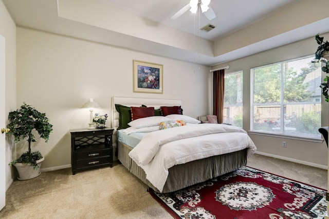 4714 Schiller Park Ln, Sugar Land, TX 77479 - bedroom with light colored carpet, ceiling fan, and a raised ceiling
