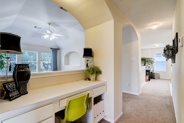 4714 Schiller Park Ln, Sugar Land, TX 77479 - home office with built in desk, light colored carpet, ceiling fan, plenty of natural light, and lofted ceiling