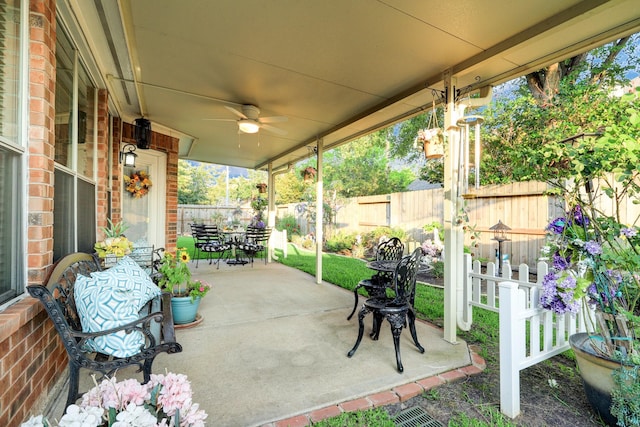 4714 Schiller Park Ln, Sugar Land, TX 77479 - fenced backyard with outdoor dining space, a ceiling fan, and a patio