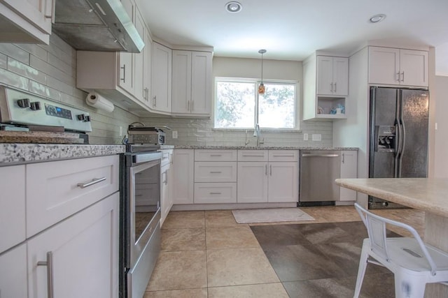3834 Gamlin Bend Dr, Houston, TX 77082 - kitchen featuring appliances with stainless steel finishes, range hood, tasteful backsplash, light stone countertops, and recessed lighting