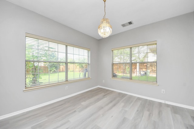 6803 Chapelfield Ln, Houston, TX 77049 - unfurnished room featuring wood finished floors and a chandelier