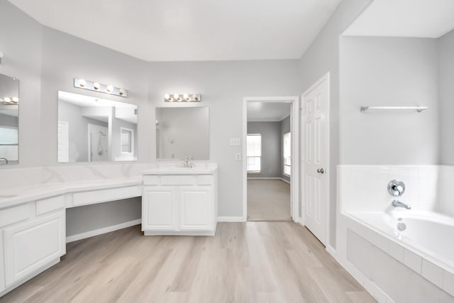 6803 Chapelfield Ln, Houston, TX 77049 - bathroom with vanity, a garden tub, and wood finished floors